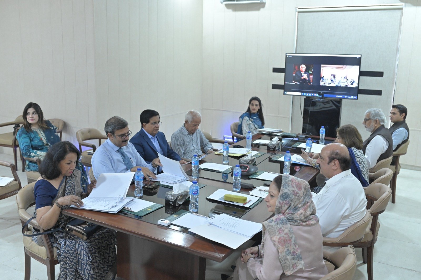 Officials in a Higher Education Department review meeting around a conference table