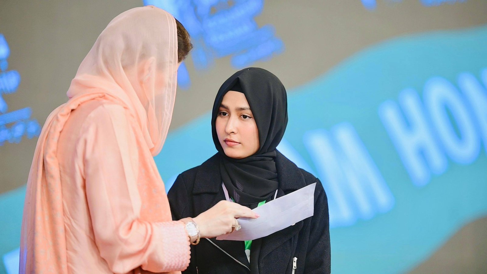 Students receiving Honhaar Scholarship certificates on stage at a Punjab ceremony