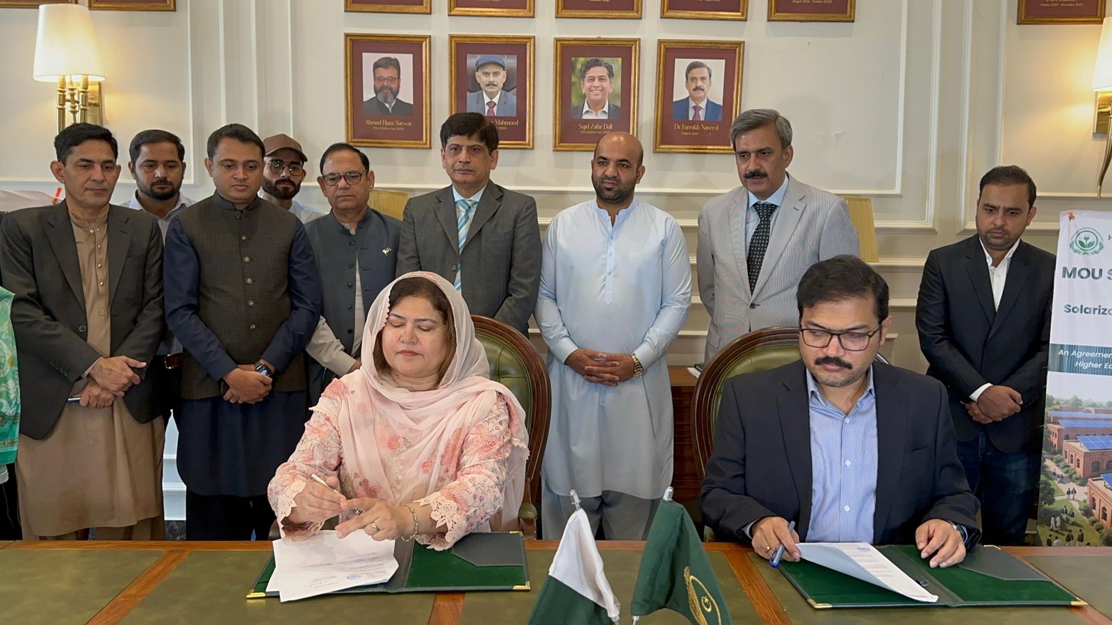 Officials at the table during the solarization MoU signing